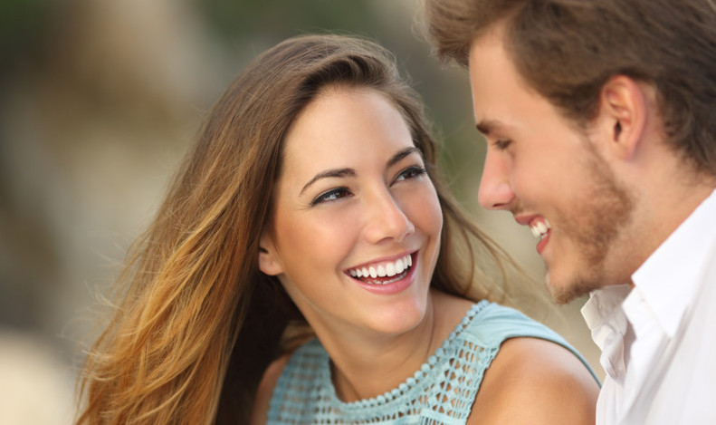 man and woman smiling and laughing together 