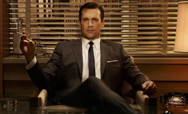 don draper sitting in a confident position