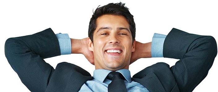 man leaning back relaxed with his hands behind his head