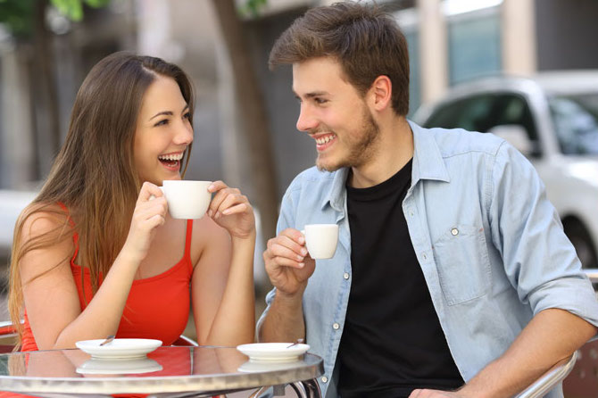 man and woman interested in each other drinking coffee