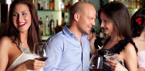 man and woman talking at a bar