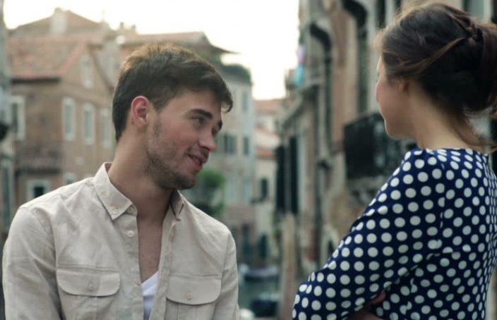 man and woman talking on a bridge