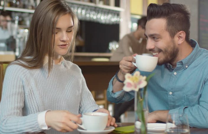 man and woman talking over coffee