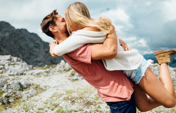 Man lifting a woman up in a hug